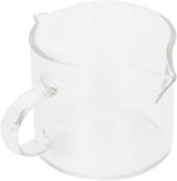 Small clear glass creamer pitcher with spout and handle on a white background