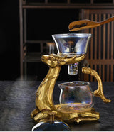 RORA gold deer magnetic tea set with a wooden scoop of tea leaves