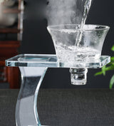 Close-up RORA glass brewing bowl on stand with hot water poured and rising steam