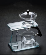 RORA glass gravity tea set with brewing bowl, black knob and pitcher on a grey background