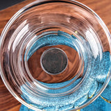 Top-down RORA glass tea dripper with mesh filter on a blue deer stand base