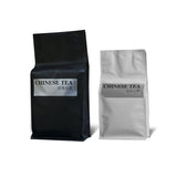 Wuyi rock tea and Lapsang Souchong tea pouches, black and silver packaging